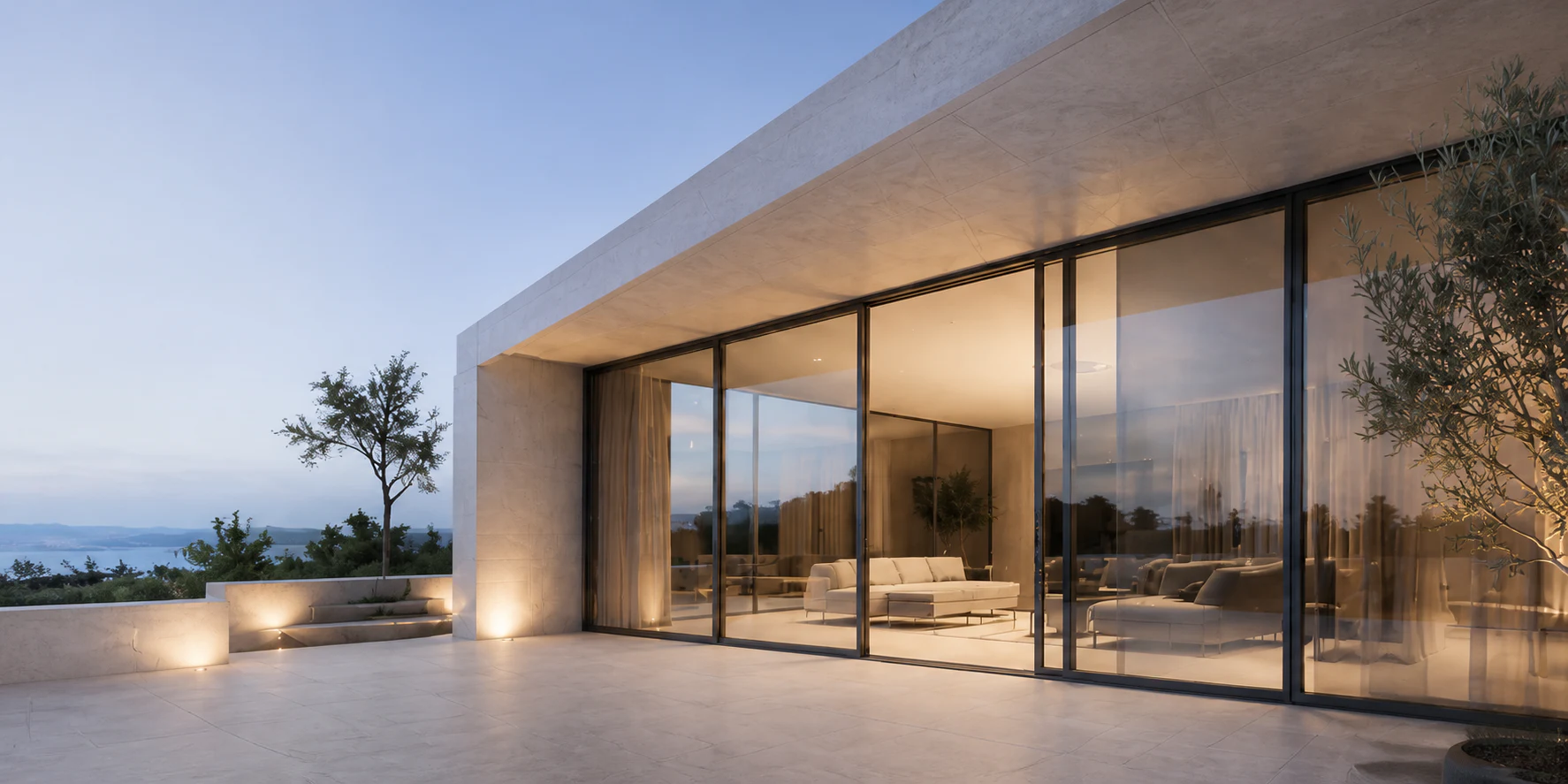 Vivienda contemporánea con grandes cerramientos de aluminio al atardecer